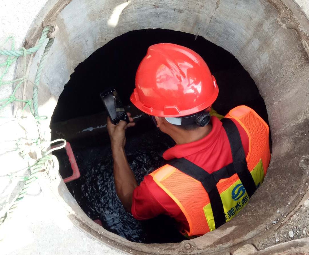 13-圖為水務(wù)工程公司黨員排查污水井內(nèi)是否有堆積垃圾、水流是否暢通等情況.jpg